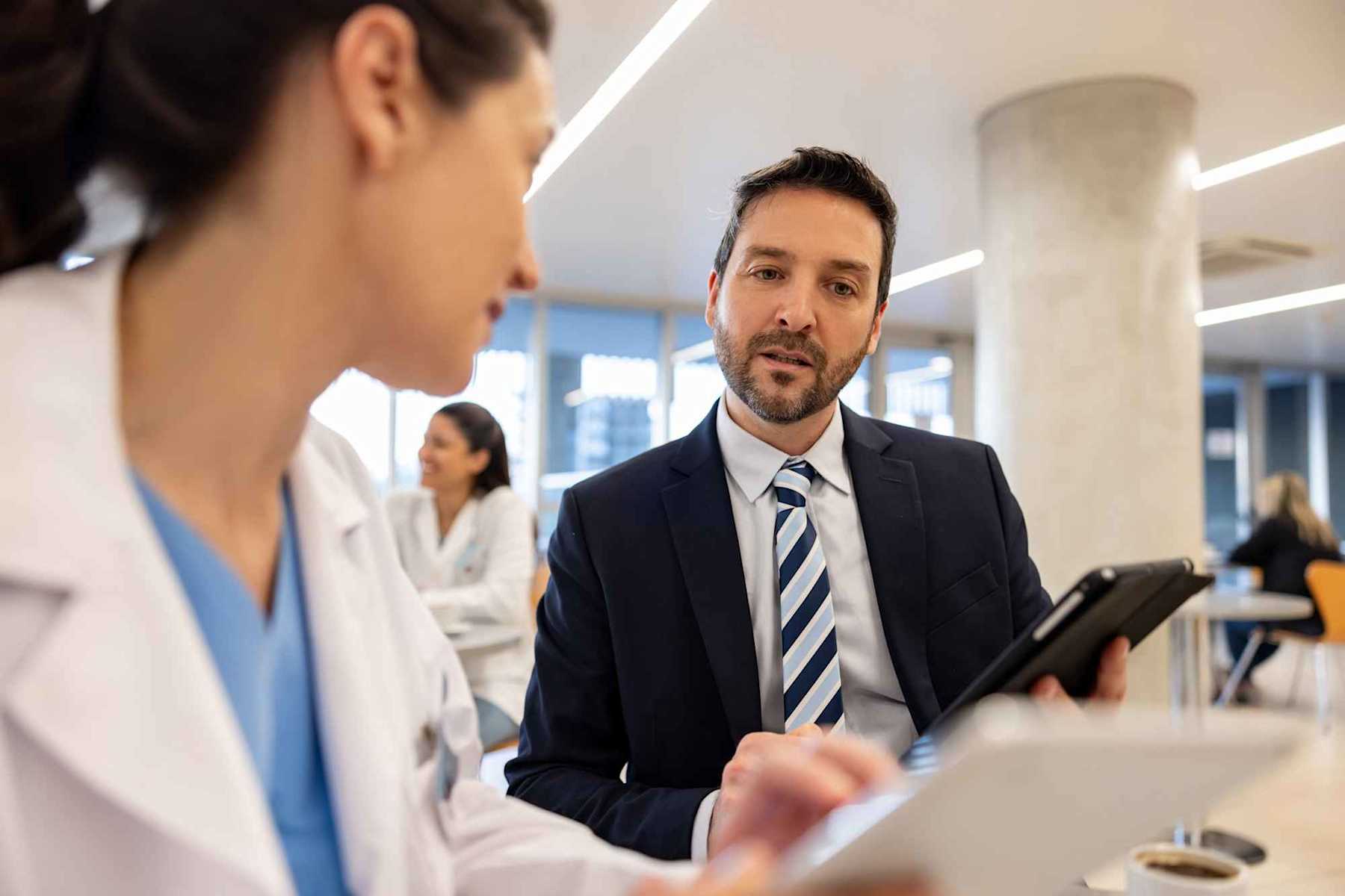 Healthcare administrator speaking to doctor